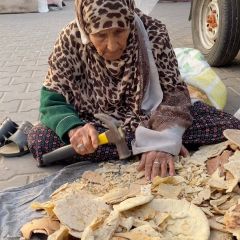 |This woman collects dry bread, breaks it, and then puts it as food for her birds that she brought with her to the place of displacement. She cannot abandon him and considers him a member of her...