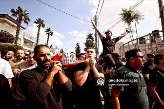 |وداع الشهييد الطفل أيهم الشافعي ١٤ عاماً في مدينة البيرة.
تصوير:  عصام الريماوي.

Israeli fire kills 3 Palestinians, 2 of which...
