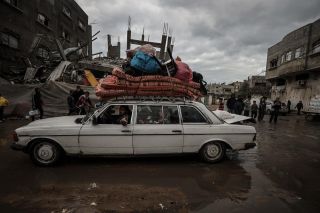 Residents leave their homes with their belongings after the Israeli army attacked the eastern part of the Nuseirat refugee camp and sent a notice asking the people to leave the area in Deir al Balah,...