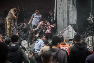 Palestinians rescue a woman from a destroyed building following Israeli airstrikes in Khan Younis refugee camp, southern Gaza Strip, Thursday, Dec. 7, 2023.
Photo by Mohammed...