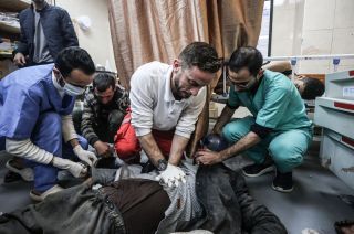 Doctors provide first aid to Palestinian people, including children, injured as a result of Israeli attack and brought to the Al-Aqsa Martyrs Hospital while the attacks carried out by the Israeli...