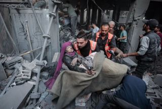 Palestinian rescuers evacuate an injured woman that was found under the rubble of a destroyed house following an Israeli airstrike in Khan Younis refugee camp, southern Gaza Strip, Saturday, Nov. 18,...
