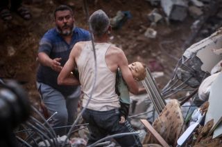 Photo 1,2- Palestinians carry a dead child was found under the rubble of a destroyed building following Israeli airstrikes in Nusseirat refugee camp, central Gaza Strip, Tuesday, Oct. 31, 2023.
Photo...