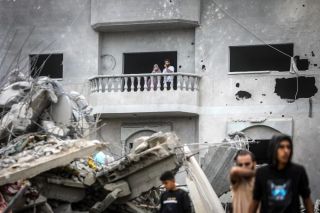 A couple looks on from the balcony of a damaged house as people inspect the damage following an Israeli bombardment in Khan Yunis in the southern Gaza Strip on November 12, 2023.
by Mohammed...
